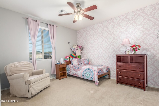bedroom with wallpapered walls, carpet floors, baseboards, and a ceiling fan