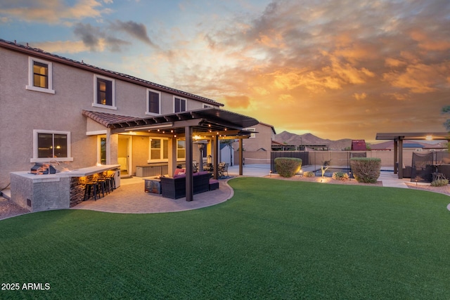back of house with stucco siding, a patio area, a tiled roof, and an outdoor hangout area