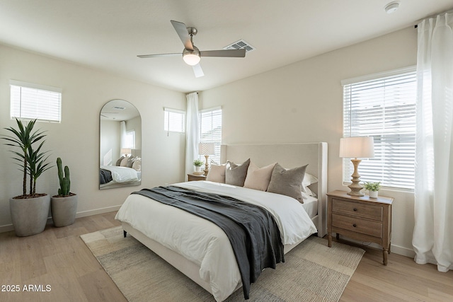 bedroom featuring light wood-style flooring, baseboards, and ceiling fan