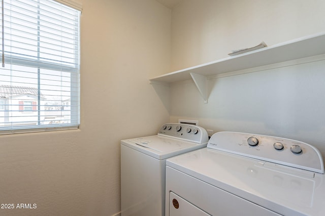 clothes washing area with independent washer and dryer
