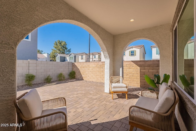 view of patio featuring a fenced backyard and a residential view