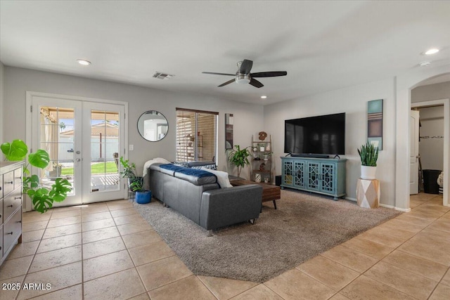 1703 E Palo Blanco Way, Gilbert, AZ 85296 - living area with french doors, ceiling fan, light tile patterned floors, arched walkways, and recessed lighting