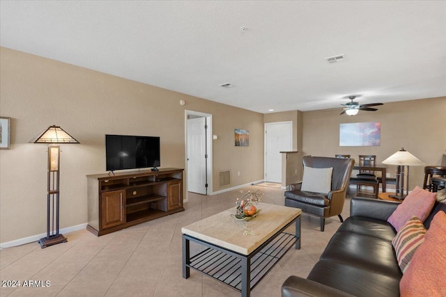 tiled living room with ceiling fan