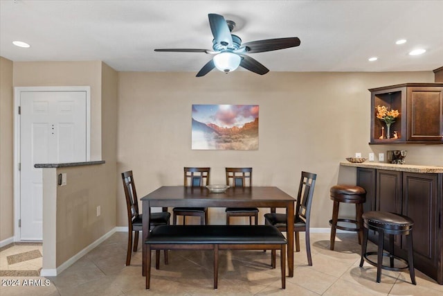 dining space featuring ceiling fan and light tile patterned floors