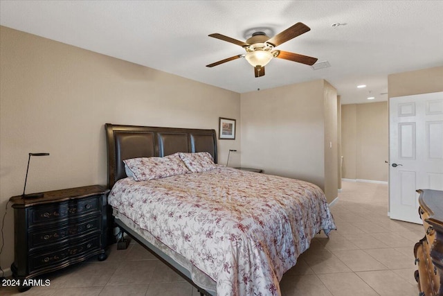 tiled bedroom featuring ceiling fan