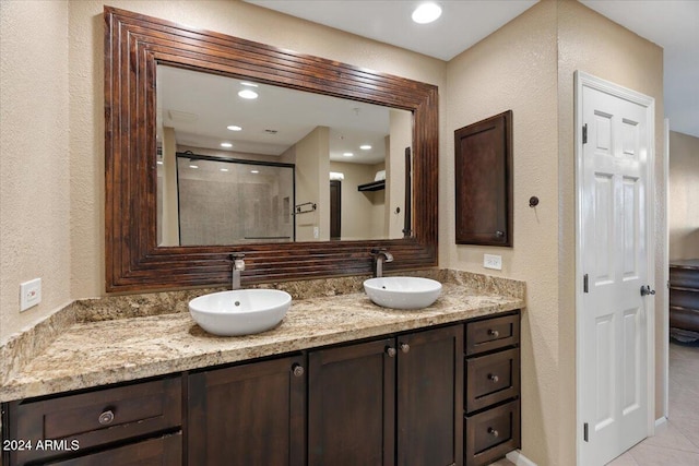 bathroom featuring vanity, tile patterned floors, and walk in shower