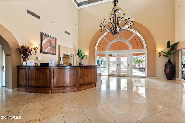 reception featuring a chandelier and french doors