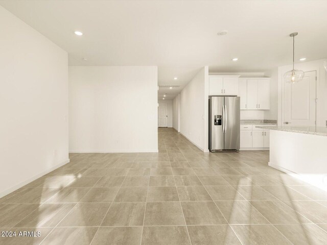 unfurnished living room with light tile patterned flooring