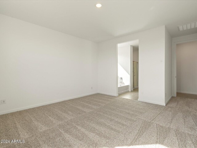 spare room with light colored carpet