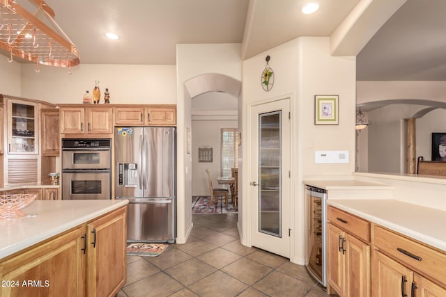 kitchen with light brown cabinetry, tile patterned flooring, stainless steel appliances, and wine cooler