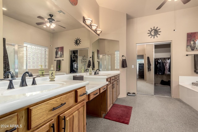 bathroom with ceiling fan, shower with separate bathtub, and vanity