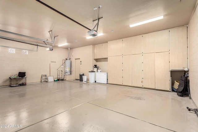 garage with a garage door opener and water heater