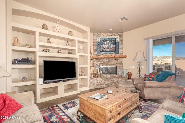 living room with dark tile patterned flooring, built in features, and a fireplace