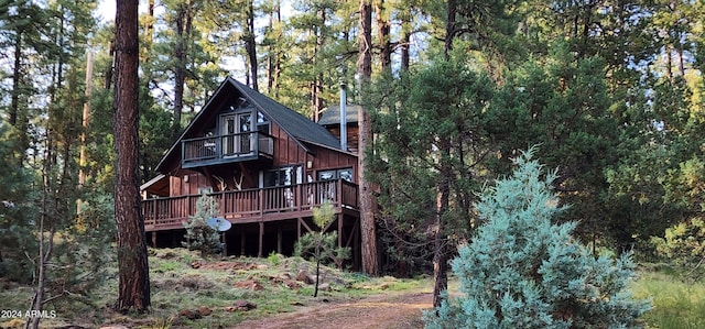 back of house with a wooden deck