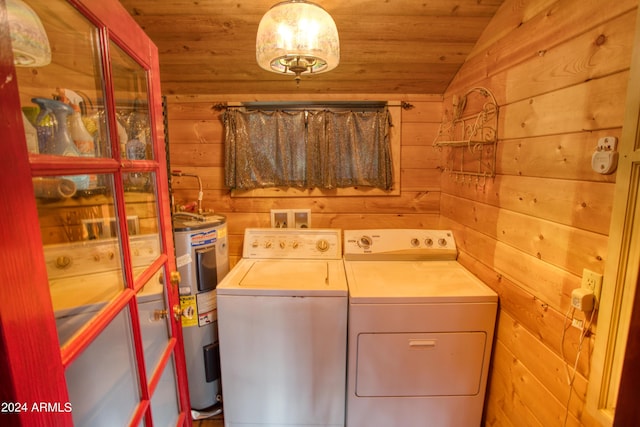 laundry room featuring laundry area, wood walls, wood ceiling, water heater, and washer and clothes dryer