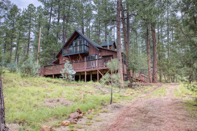 rear view of house featuring a wooden deck