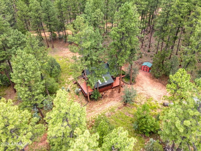 drone / aerial view featuring a wooded view