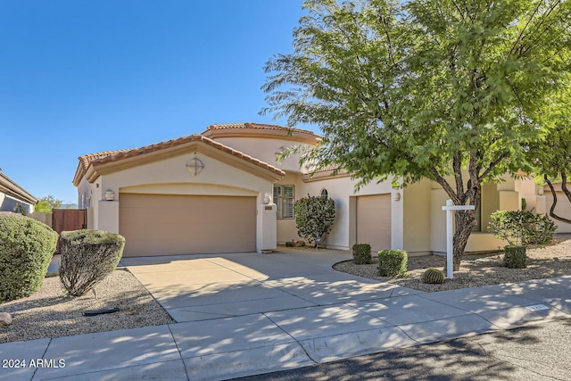 mediterranean / spanish-style home featuring a garage