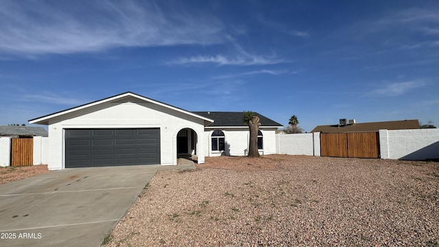 4125 W Villa Rita Dr, Glendale, AZ 85308 - ranch-style home with concrete driveway, an attached garage, stucco siding, and a gate