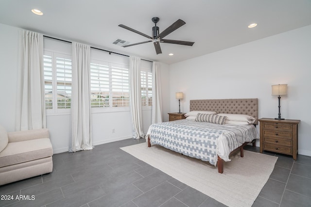 tiled bedroom featuring ceiling fan