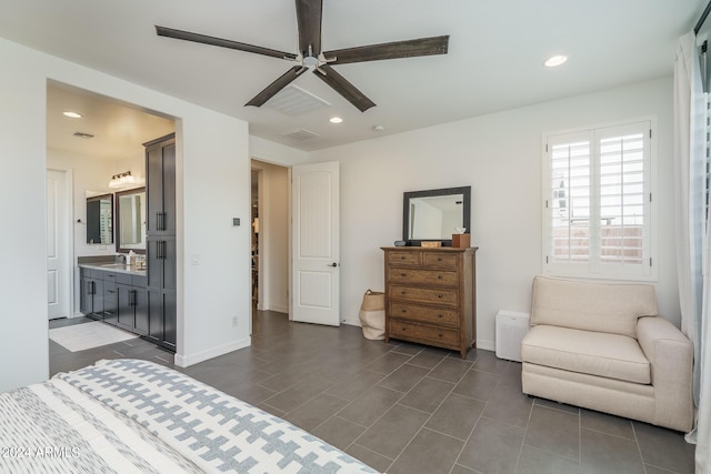 bedroom with ceiling fan, ensuite bathroom, and sink