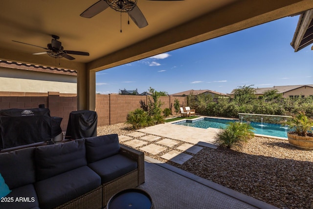 view of swimming pool featuring pool water feature, ceiling fan, grilling area, and a patio