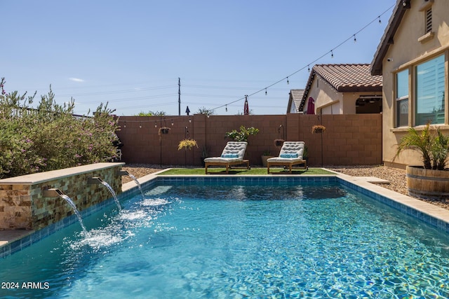 view of swimming pool with pool water feature