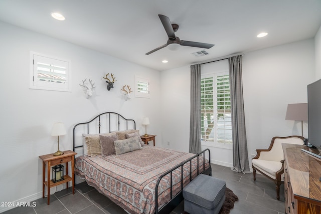 bedroom with dark tile patterned flooring and ceiling fan