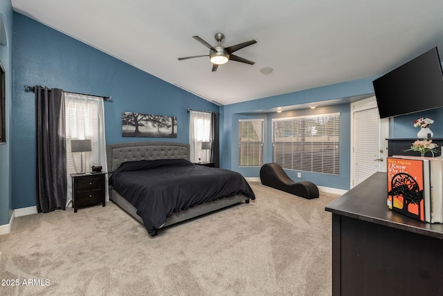 bedroom featuring vaulted ceiling, a ceiling fan, baseboards, and light carpet