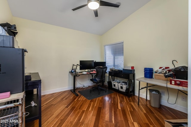 home office featuring lofted ceiling, wood finished floors, a ceiling fan, and baseboards