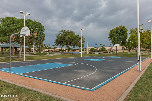 view of sport court with a lawn and community basketball court