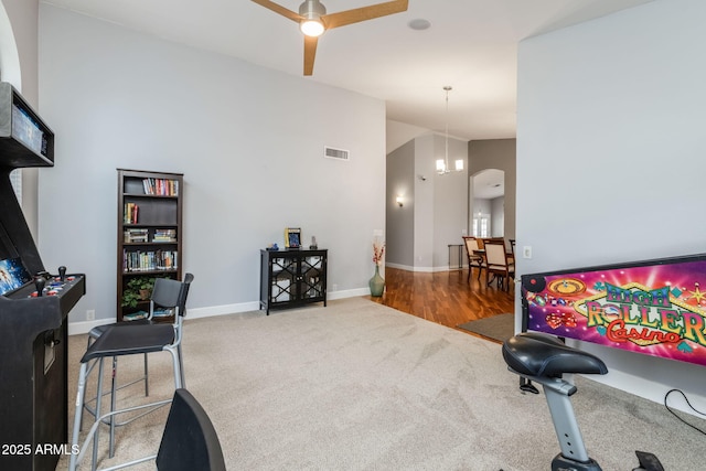 workout area featuring visible vents, high vaulted ceiling, carpet, baseboards, and ceiling fan