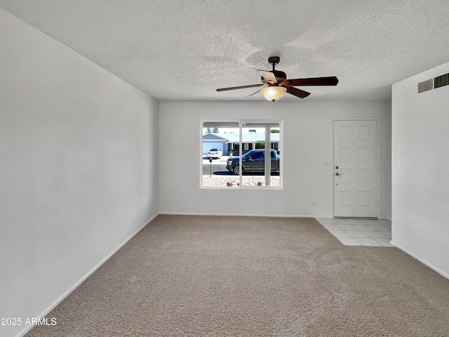 2127 W Marco Polo Rd, Phoenix, AZ 85027 - empty room featuring light carpet, ceiling fan, a textured ceiling, and baseboards