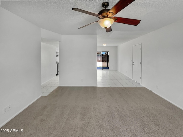 2127 W Marco Polo Rd, Phoenix, AZ 85027 - tiled spare room featuring a ceiling fan, carpet, a textured ceiling, and baseboards