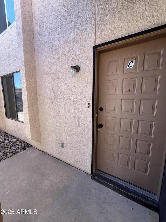 entrance to property with stucco siding