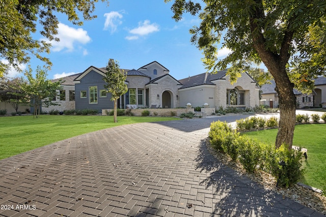 french country inspired facade with a front lawn