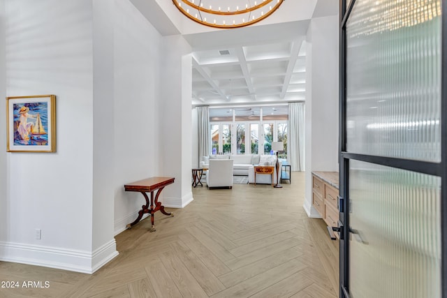 hallway with an inviting chandelier, light parquet flooring, beamed ceiling, and coffered ceiling