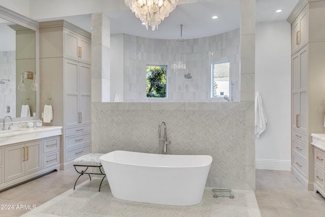 bathroom featuring tile walls, vanity, a notable chandelier, plus walk in shower, and tile patterned flooring