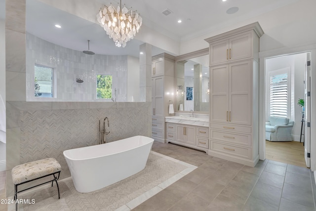 bathroom with vanity, a healthy amount of sunlight, independent shower and bath, and tile walls