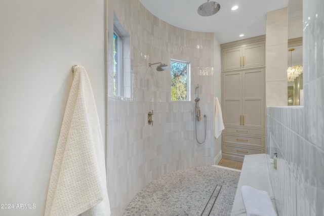 bathroom featuring tiled shower and tile patterned flooring