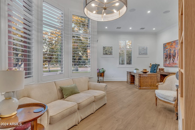 interior space with a notable chandelier, ornamental molding, plenty of natural light, and light wood-type flooring