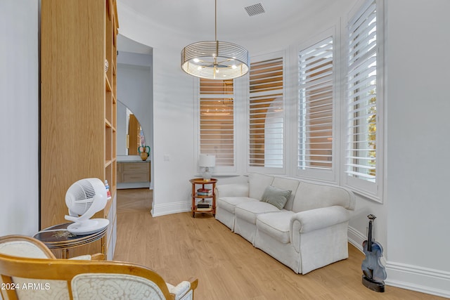 living area featuring an inviting chandelier and light wood-type flooring