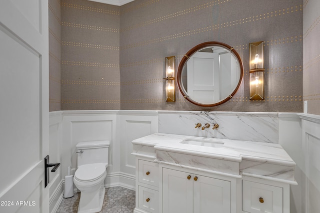 bathroom featuring vanity, toilet, and tile patterned flooring