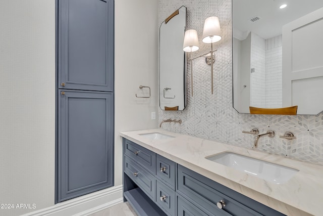 bathroom featuring vanity and tasteful backsplash