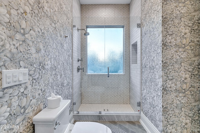 bathroom featuring toilet and an enclosed shower