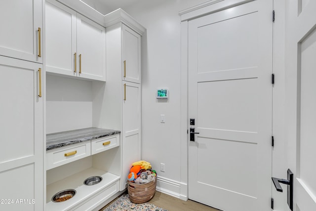 laundry room with light hardwood / wood-style floors