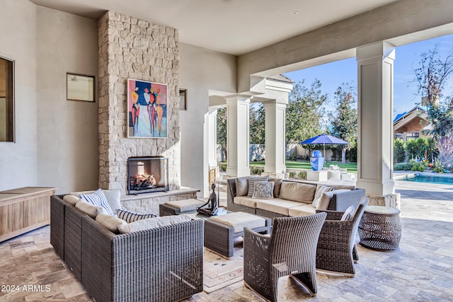 view of patio with an outdoor living space with a fireplace, a swimming pool, and radiator