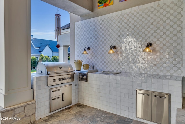 view of patio with an outdoor kitchen and grilling area