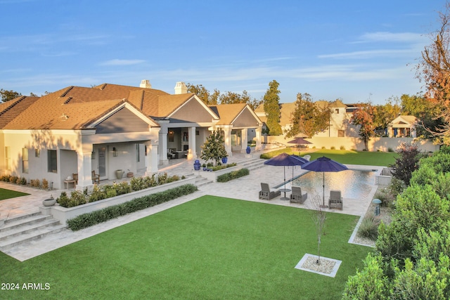 rear view of property with a patio area and a lawn