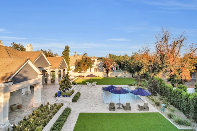 view of swimming pool featuring a patio and a lawn